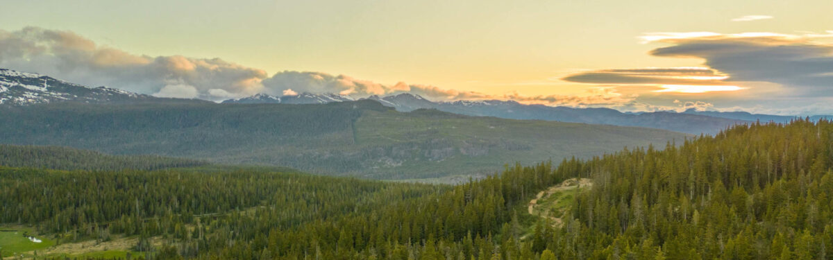 Golden sunset over forested mountains at Mount Washington.